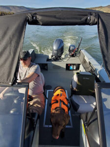 Eric Nelson and his pooch, Calamity Jane, in his boat.